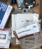 Box Of New Unused Electrical Items And A Used Respirator