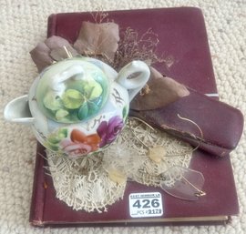 Vintage Book Art Display With Tea Cup, Glasses, Doily & More Glued To The Top Of The Book