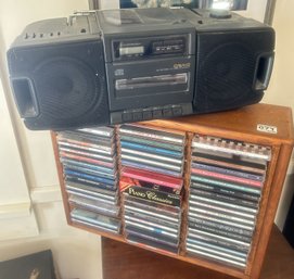 Craig AM/FM/CDCassette Compact Disc Player & Wooden CD Rack, 18' X 5' X 14'H, Filled With 49 CDs And Or DVDs