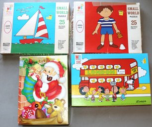 Four Puzzles - 2 Small World - 1 Milton Bradley - Peanuts - 1 Springbok Santa's Surprise