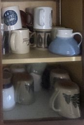 Cabinet Door With Various Stoneware And Ceramic Coffee Mugs